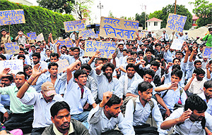 Striking employees of Rockman and Satyam factories hold a demonstration in support of their demands in front of the Secretariat in Dehradun on Wednesday