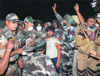 Rescuers with Nitesh, who was pulled out after 72 hours from the collapsed factory site in Jalandhar at 12.40 am on Thursday