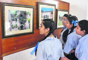 Schoolchildren watch paintings during the exhibition organised on World Heritage Day at Kala Kendra in Jammu on Wednesday. 