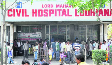 Patients stand outside the OPD wing of Lord Mahavir Civil Hospital, Ludhiana, on Wednesday. 