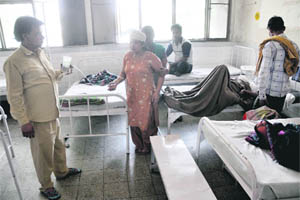 A patient being attended to by a family member at the womens ward in the Civil Hospital. 