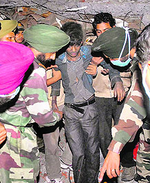 Members of a rescue team bring out Sanjiv on Tuesday night.