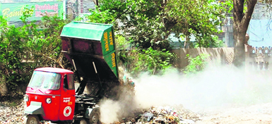 A garbage-collecting vehicle dumps garbage at Company Bagh in Amritsar