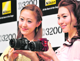 Japanese optics giant Nikon Corporation unveils the new entry model of the D3200 digital single-lens reflex camera with a 24 megapixel CMOS image sensor on its lightweight body in Tokyo on Thursday. Nikon will put the new SLR camera, which is enabled to connect to the newly developed Wi-Fi adaptor, on the market next month