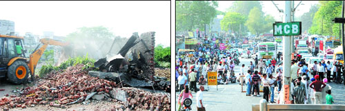 Demolition drive in progress at the market near the Rose Garden. Shopkeepers squat on the roads (right) and block traffic to protest against the demolition drive by Bathinda Improvement Trust.
