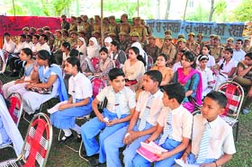 Students participate in a debate competition as part of Fire Safety Week celebrations in Jammu on Thursday