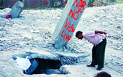 A man looks into the debris as the NDRF team declared no victim live in an area of the factory collapse site in Jalandhar on Thursday