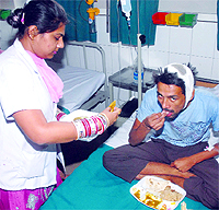An injured worker being served food after the visit of Principal Secretary, Health, Binny Mahajan to the Civil Hospital in Jalandhar on Thursday