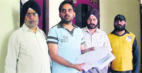 Relatives of Harman Dhingra stand outside the district education office to submit a memorandum in Ludhiana on Thursday.
