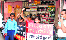 Students protest in front of a liquor vend at Dr Ambedkar Nagar in Ludhiana on Thursday.