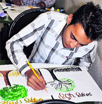 A student participates in a poster-making contest at the PAU  in Ludhiana on Thursday.