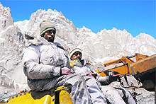 Pakistani military personnel use heavy machinery to search for avalanche victims during an ongoing operation at the Gayari camp near the Siachen glacier. 