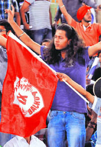 Supporters of Kings XI Punjab celebrate the wicket of MA Agarwal of Royal Challengers Bangalore at the PCA Stadium in Mohali on Friday.