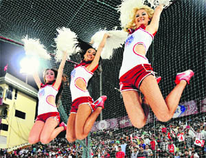 Cheerleaders of Kings XI Punjab jump to celebrate a sixer by DJ Hussey against Royal Challengers Bangalore at the PCA stadium in Mohali on Friday