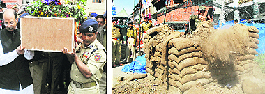 Minister of State for Home Nasir Aslam Wani along with IGP SM Sahai carries the coffin of ASI Sukhpal Singh in Srinagar; (right) A CRPF soldier empties a sandbag during the removal of a bunker in the Lal Chowk area in Srinagar on Friday. 