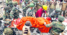 Army jawans take out a body of Shantu Kumar from the debris of the collapsed factory site in Jalandhar on Friday.