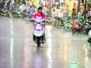 A woman crosses a road as rain hit the city on Friday evening.