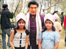 Veteran actor Asrani flanked by child stars Ekta and Ritika Kapoor during the shooting of the Punjabi film Kissa.