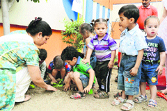 Students of Rising Star School plant a sapling on the school campus on World Earth Day in Ludhiana on Friday. 