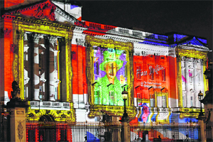 A projection formed of self-portraits of over 200,000 children form a montage image of Britains Queen Elizabeth II on the frontage of Buckingham Palace in London in an event organised by The Princes Foundation for Children and the Arts.