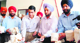 Officials of the State Special Operation Cell with the contraband and arms seized in Amritsar on Saturday.