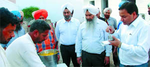 District and sessions judge , SK Aggarwal, examines the quality of food prepared for the inmates of the Central Jail in Bathinda on Saturday. 