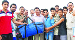 RS Chib, Minister for Youth Services and Sports, distributes sports kits among the youth at RS Pura in Jammu