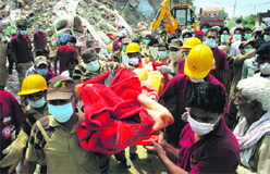 The body of a victim being taken out of the debris of the collapsed Shital Fibres factory in Jalandhar on Saturday. 
