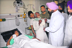 Vikramjit Singh Chaudhary, president, Punjab Youth Congress, talks to the injured at the Civil Hospital in Jalandhar on Saturday. 