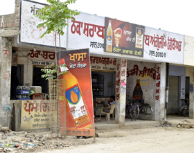 An over-sized advertising board outside a vend in Badal village of Muktsar district. 