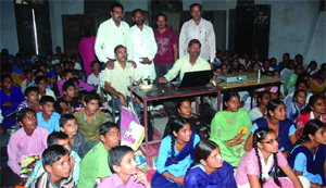 Members of the Teachers Club impart coaching to poor students with the help of a projector, at a government school. 