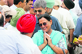 Golf club members greet each other during the election in Chandigarh on Sunday. 