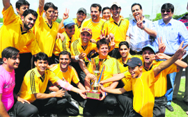 The Dabur India cricket team pose with the trophy after winning the tournament at the Sector-16 cricket stadium in Chandigarh on Sunday. 