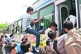 A candidate, who had come to appear for the BSF entrance examination, tries to enter a crowded bus through a window at the Sector-17 ISBT, Chandigarh, on Sunday.