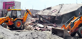 JCB machines demolish shops in Kaithal on Sunday.