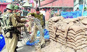 A CRPF bunker being removed in Lal Chowk, Srinagar