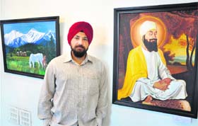 A painter with his paintings at the exhibition