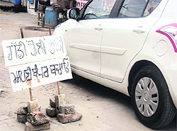 A makeshift signboard installed by shopkeepers on Railway Road Jagraon cautioning commuters to drive slow and save their vehicles’ bumpers