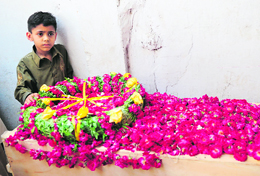 A child stands next to the coffin of his father, who died in Fridays crash, during the funeral in Karachi.