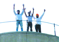 Members of the Special Trainer Teachers Union atop a water tank in Bhokra village. 