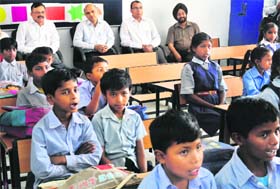 Adviser to UT Administrator KK Sharma (second from left) sits with students at the smart school in Sector 53, Chandigarh, on Monday