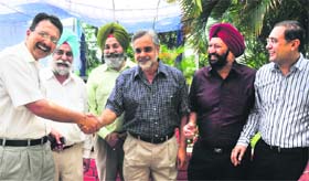 Members of the Chandigarh Golf Club congratulate GS Sandhu (centre) in Chandigarh on Monday