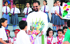 Brother AJ George, Principal of St Josephs Academy, being felicitated by students on his feast day in Dehradun 