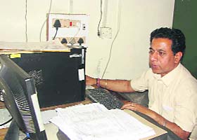 An official uploads e-salary bills at the Treasury Office in Kurukshetra