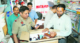 Health Department officials, along with policemen, conduct a raid at a chemists shop in Kochhar Market in Ludhiana on Monday.