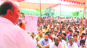 A member of the Punjab State Municipal Karamchari Dal addresses a gathering of the safai karamcharis at the MC Zone A office in Ludhiana on Monday.