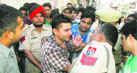 Gaurav argues with police in Ludhiana on Monday.