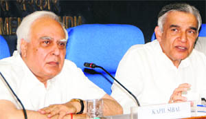 Kapil Sibal and PK Bansal at a press conference in New Delhi on Monday. 