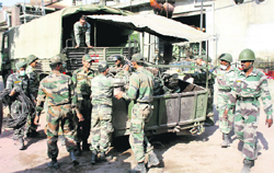 Army jawans load equipment into a truck as rescue operation nears closure in Jalandhar