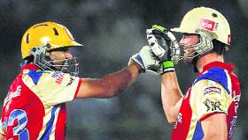 Royal Challengers Bangalores Tillakaratne Dilshan and AB de Villiers celebrate a boundary against Rajasthan Royals during their match in Jaipur on Monday